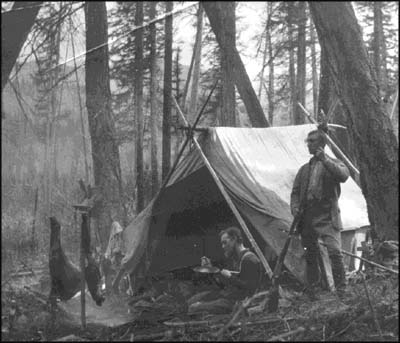 two hunters at a camp