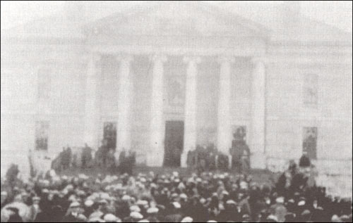 photo of a crowd of people in front of the Colonial Building in 1932
