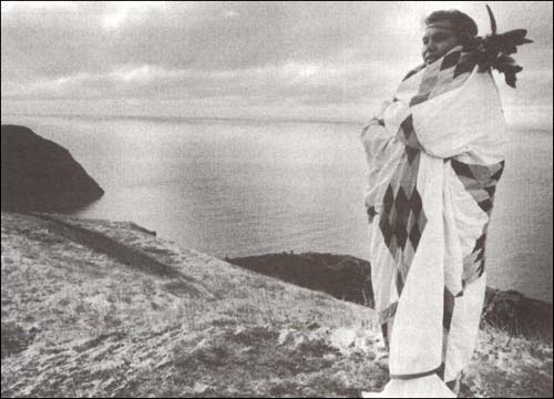 photo of a native person standing on a shore