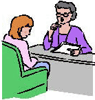 Two people talking at a desk
